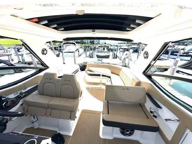 Slide: The Image of 2024 Sea Ray 320DA boat interior with luxurious seating and modern design. - 27