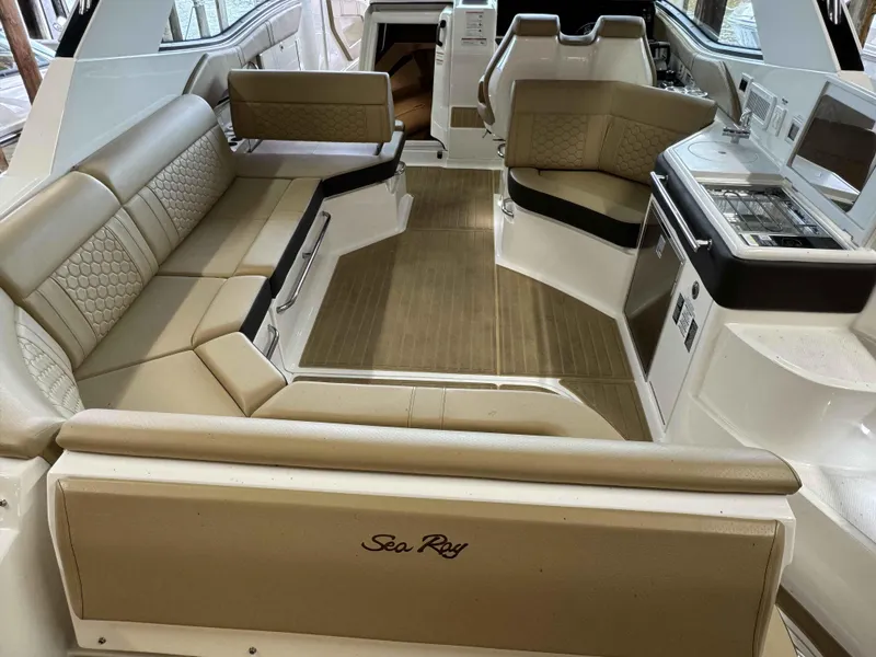 Slide: The Image of 2024 Sea Ray 320DA boat interior with beige seating and modern amenities. - 3