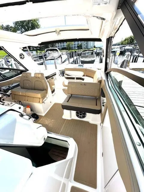 Slide: The Image of 2024 Sea Ray 320DA boat interior with beige seating and modern design. - 30