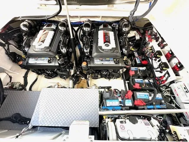 Slide: The Image of 2024 Sea Ray 320DA engine compartment with dual engines and battery setup. - 31