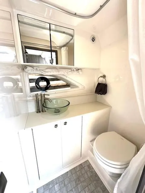 Slide: The Image of Luxurious bathroom in 2024 Sea Ray 320DA yacht with modern fixtures and elegant design. - 33