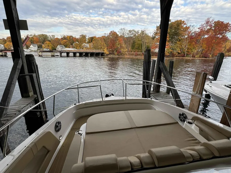 Slide: The Image of 2024 Sea Ray 320DA boat docked by scenic autumn river. - 6