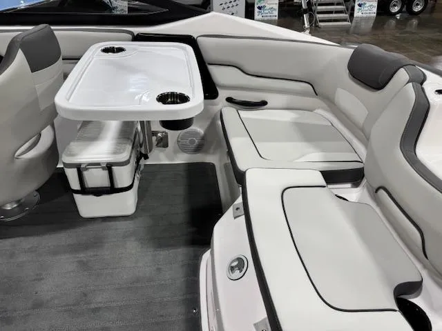 Slide: The Image of 2025 Yamaha Boats SX190 interior with seating and table, featuring modern design and cup holders. - 12