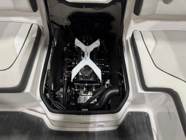 Slide: The Image of Interior of 2025 Yamaha Boats SX190, featuring seating and a table with cup holders. - 13