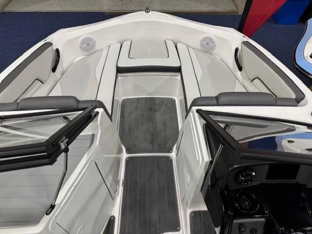 Slide: The Image of 2025 Yamaha Boats SX190 interior with seating and table, displayed in showroom. - 2