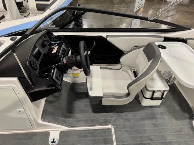 Slide: The Image of 2025 Yamaha Boats SX190 interior view, showcasing sleek seating and modern design in a showroom. - 5