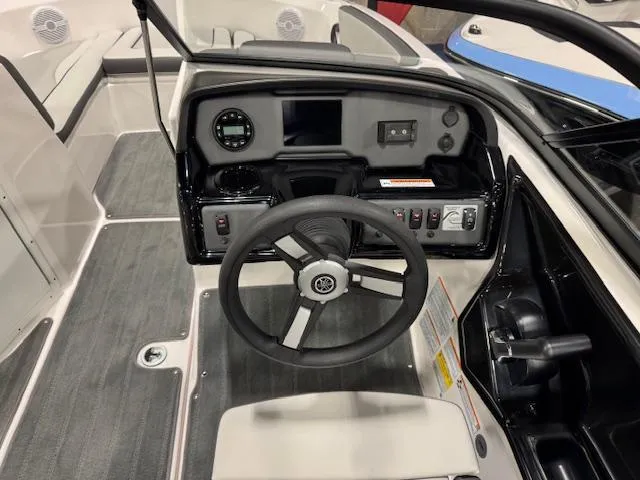Slide: The Image of 2025 Yamaha Boats SX190 interior with steering wheel, seating, and table setup. - 6