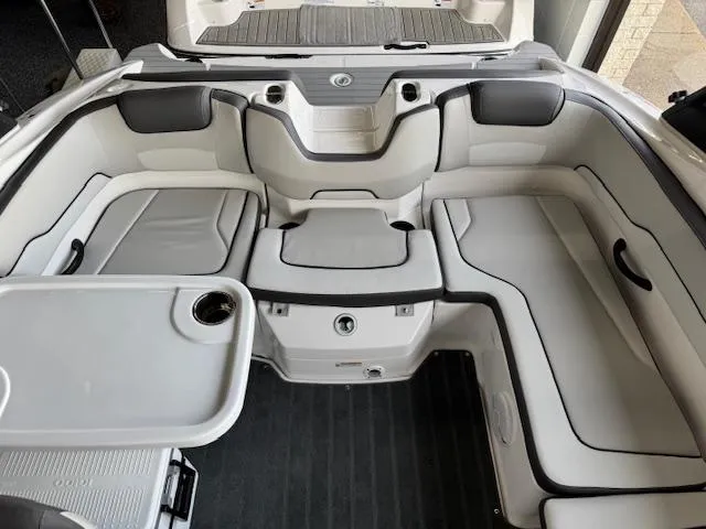 Slide: The Image of 2025 Yamaha Boats AR190 interior with sleek seating and integrated table. - 11