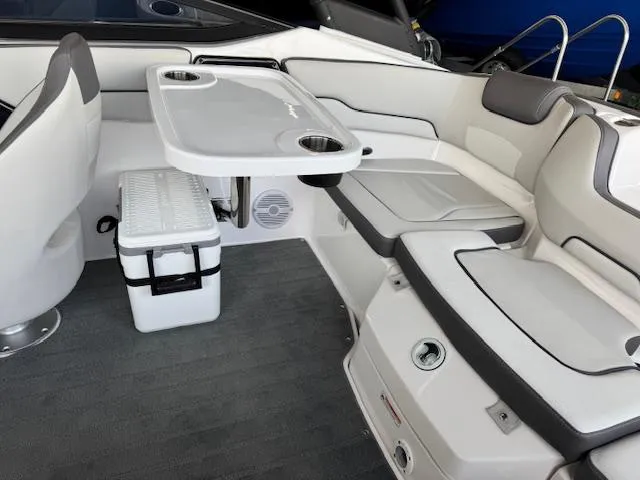 Slide: The Image of 2025 Yamaha Boats AR190 interior with seating, table, and cooler. - 12
