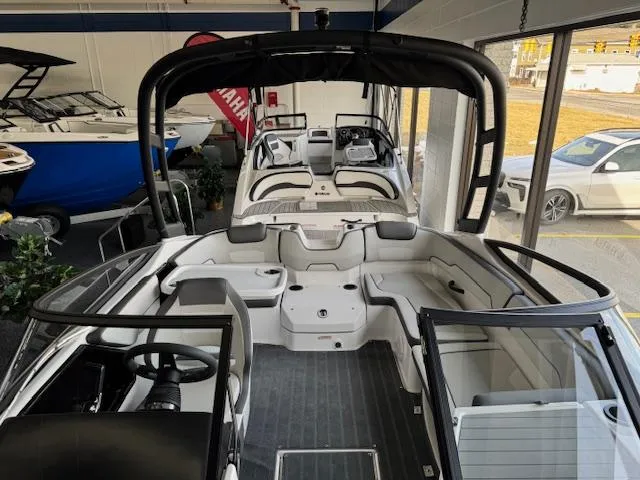 Slide: The Image of 2025 Yamaha Boats AR190 interior view in showroom, showcasing sleek design and spacious seating. - 4