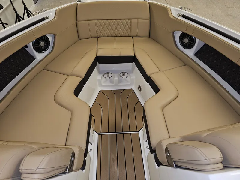 Slide: The Image of 2022 Sea Ray SLX 250 boat interior with tan leather seating and wood flooring. - 17