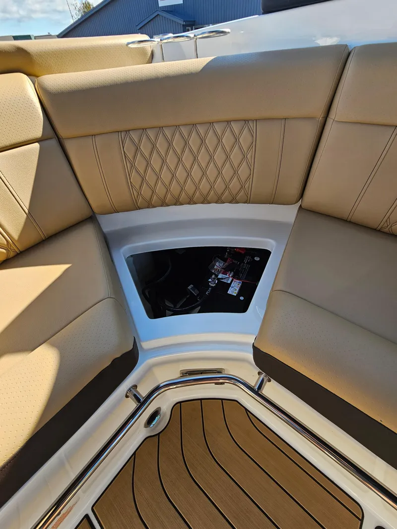 Slide: The Image of 2022 Sea Ray SLX 250 interior with tan leather seating and wood flooring. - 18