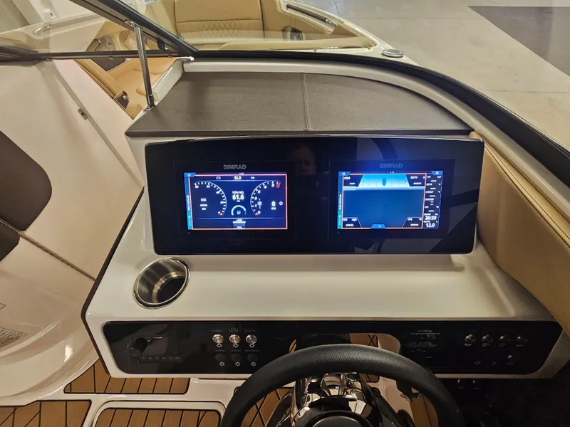 Slide: The Image of 2022 Sea Ray SLX 250 dashboard with dual Simrad displays and modern controls. - 20