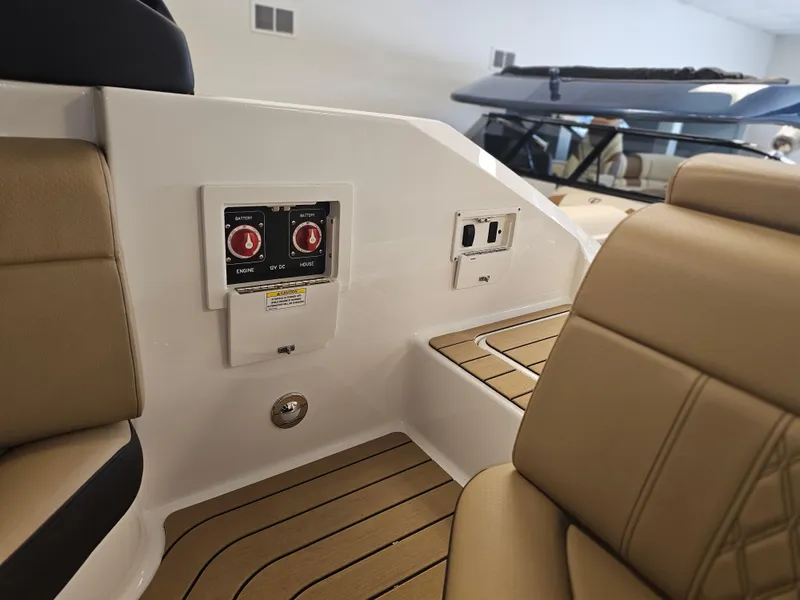 Slide: The Image of 2022 Sea Ray SLX 250 boat interior with beige seating and control panel. - 24
