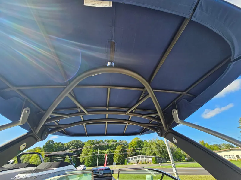 Slide: The Image of 2022 Sea Ray SLX 250 boat canopy with sunlit sky background. - 33