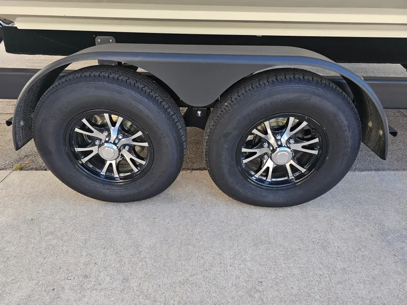 Slide: The Image of 2022 Sea Ray SLX 250 trailer wheels with sleek black rims. - 34