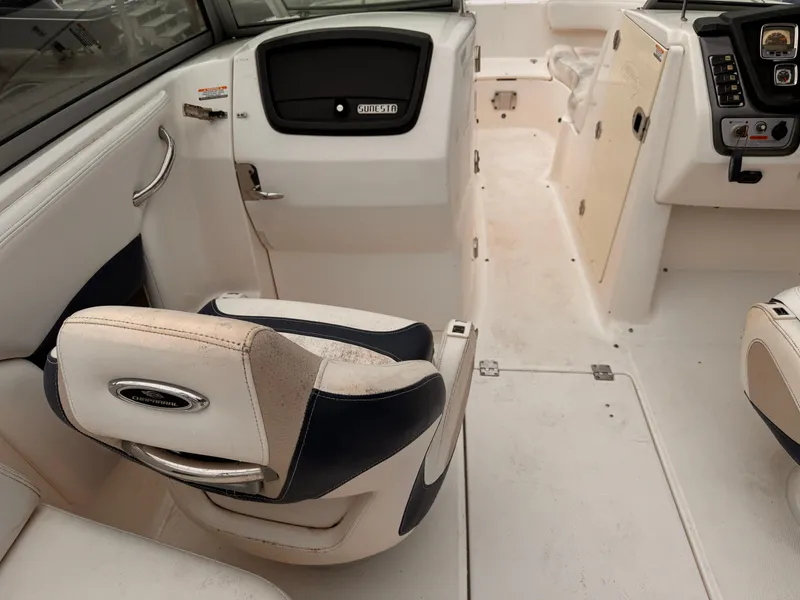Slide: The Image of Interior of 2012 Chaparral 244 Sunesta boat with seating and control panel. - 11