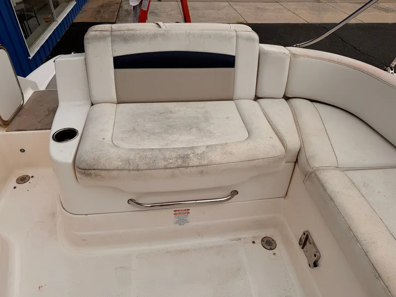 Slide: The Image of 2012 Chaparral 244 Sunesta boat seating with visible wear and dirt. - 14