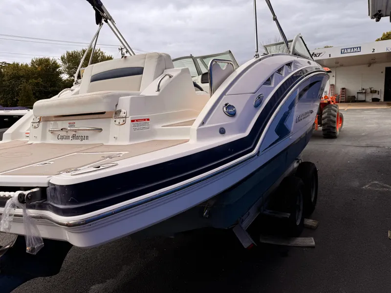 Slide: The Image of 2012 Chaparral 244 Sunesta boat on trailer, rear view, parked outdoors. - 2