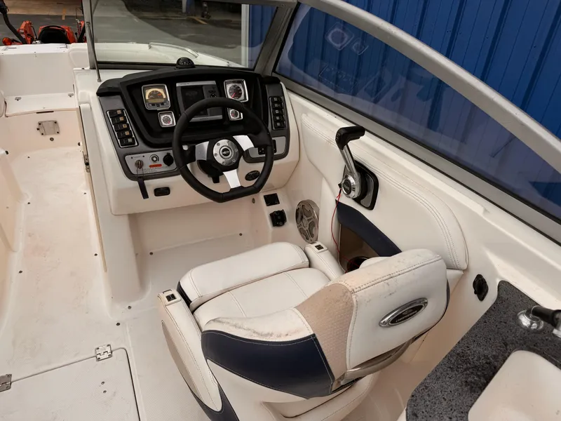Slide: The Image of 2012 Chaparral 244 Sunesta boat cockpit with steering wheel and control panel. - 8