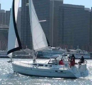 Slide: The Image of Sailboat Hunter 41, 2007 model, sailing near city skyline on a sunny day. - 1