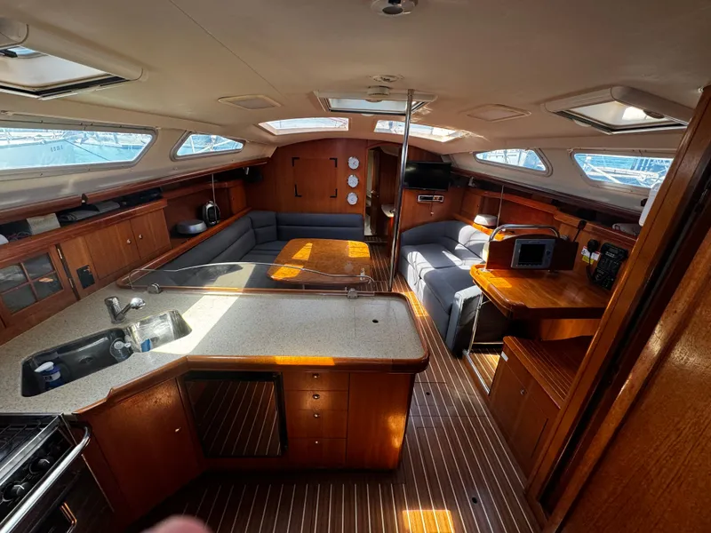 Slide: The Image of Interior of a 2007 Hunter 41 sailboat with modern kitchen and seating area. - 11