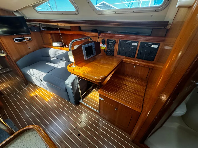 Slide: The Image of Interior of 2007 Hunter 41 sailboat with wood finish and seating area. - 12