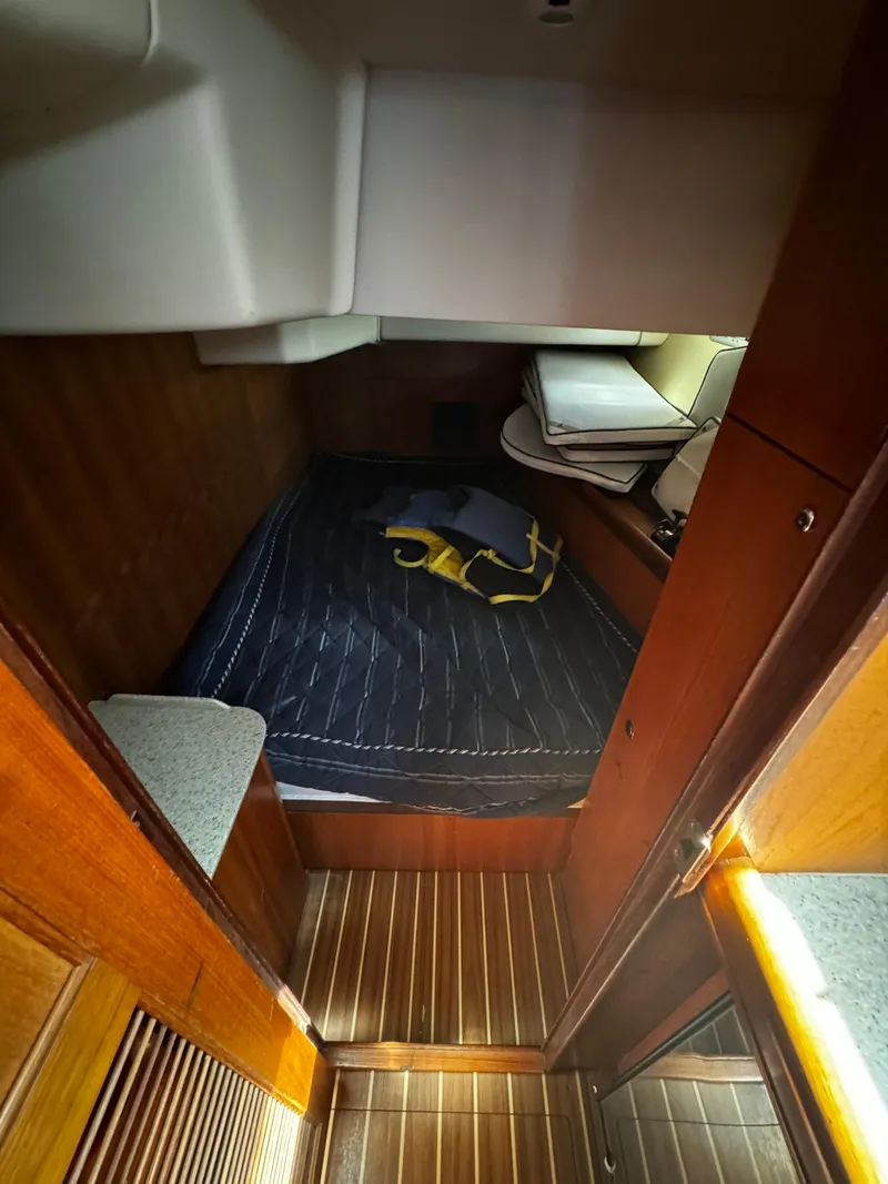 Slide: The Image of Interior cabin of a 2007 Hunter 41 sailboat with wooden flooring and cozy bedding. - 14