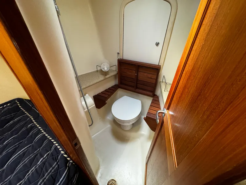 Slide: The Image of Bathroom interior of 2007 Hunter 41 sailboat with wooden accents and compact design. - 17