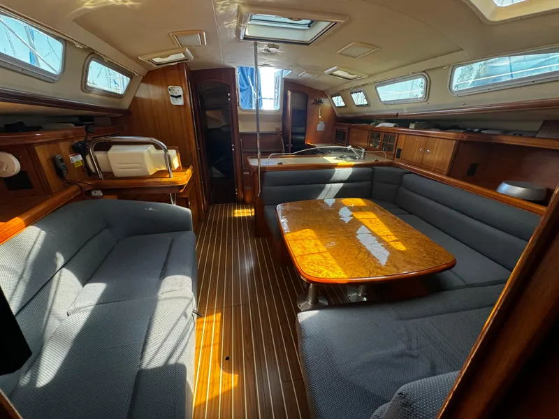 Slide: The Image of Interior of a 2007 Hunter 41 sailboat with wood finishes and seating area. - 20