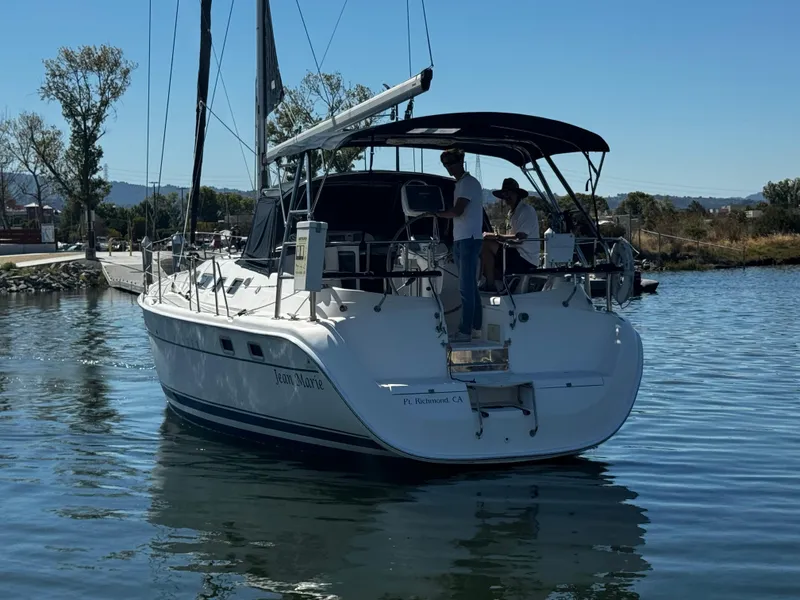 Slide: The Image of 2007 Hunter 41 sailboat on calm water, featuring a sleek design and spacious deck. - 3