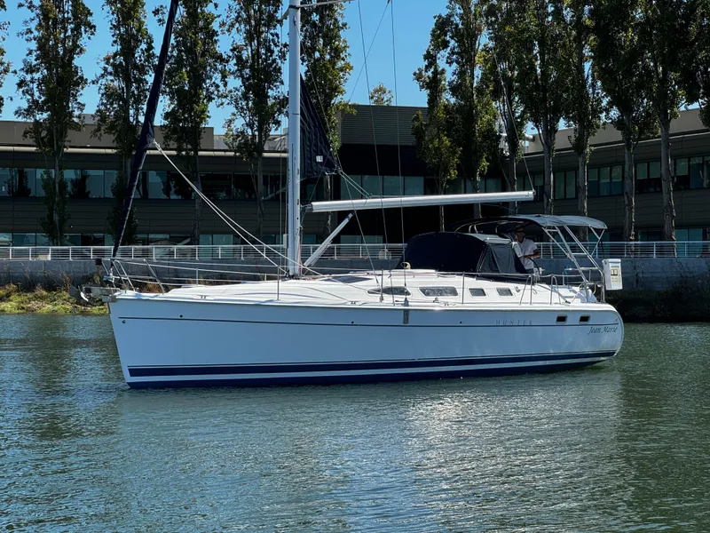 Slide: The Image of Sailboat on water, 2007 Hunter 41 model, near modern buildings and trees. - 4