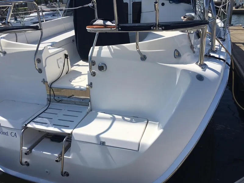 Slide: The Image of 2007 Hunter 41 sailboat stern view at dock, featuring sleek design and stainless steel railings. - 5