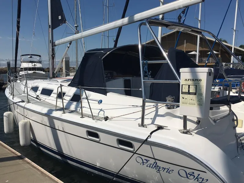 Slide: The Image of 2007 Hunter 41 sailboat docked, featuring sleek design and "Valkyrie Sky" name on hull. - 6