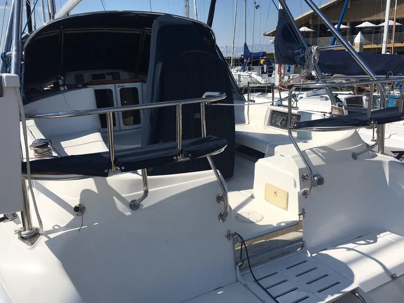 Slide: The Image of 2007 Hunter 41 sailboat cockpit with seating and steering wheel, docked at marina. - 7