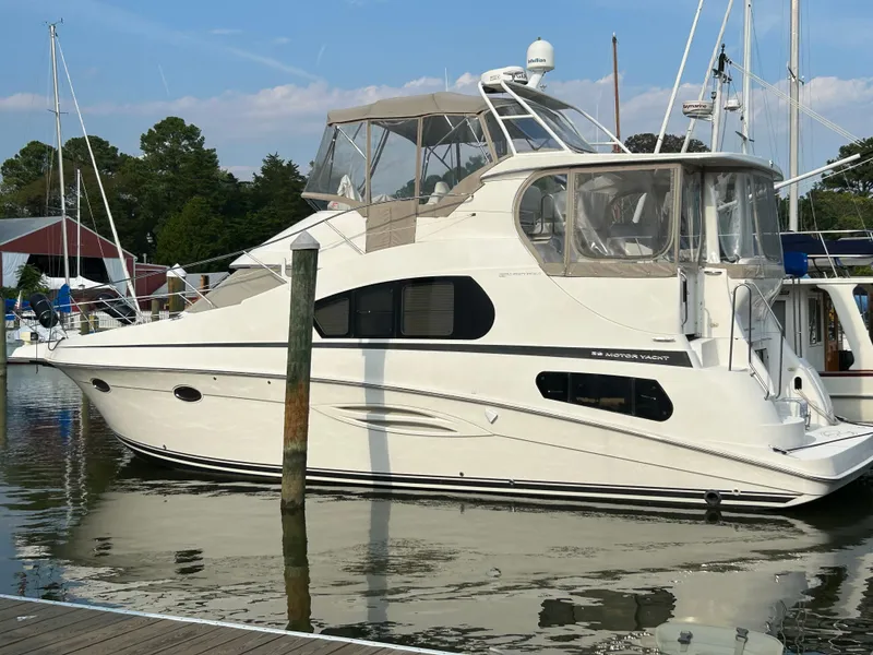 Slide: The Image of 2004 Silverton 39 Motor Yacht docked at marina, side view. - 1