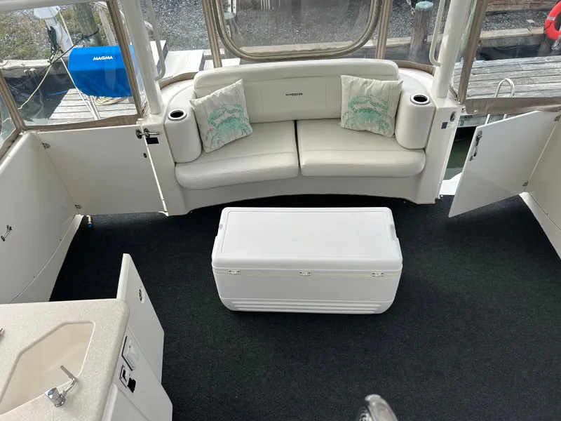 Slide: The Image of 2004 Silverton 39 Motor Yacht interior with white seating and table. - 10