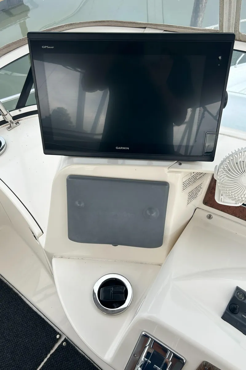 Slide: The Image of 2004 Silverton 39 Motor Yacht helm with navigation screen and controls. - 14