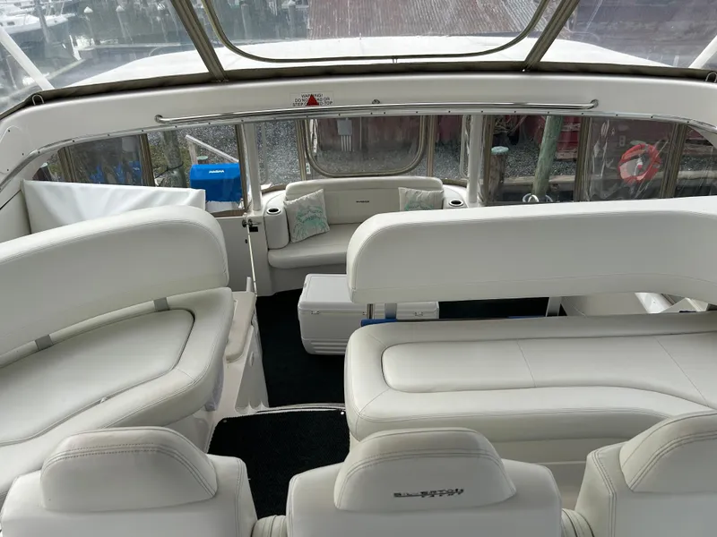 Slide: The Image of 2004 Silverton 39 Motor Yacht interior with white seating and panoramic windows. - 15