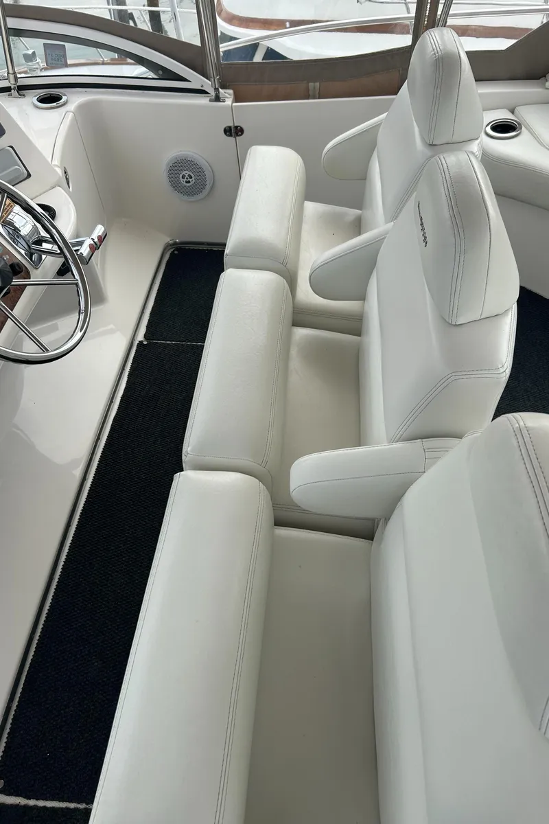 Slide: The Image of 2004 Silverton 39 Motor Yacht interior with white leather seating and steering wheel. - 16