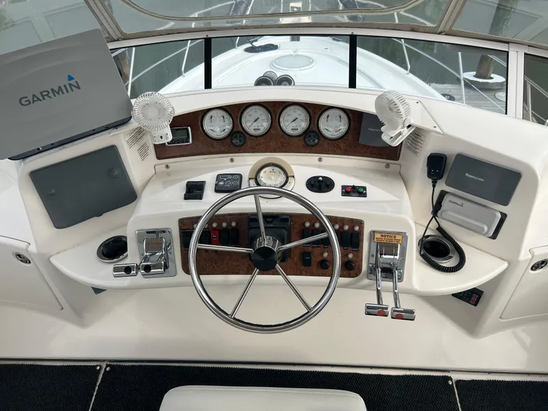 Slide: The Image of 2004 Silverton 39 Motor Yacht helm with Garmin navigation system and control panel. - 18
