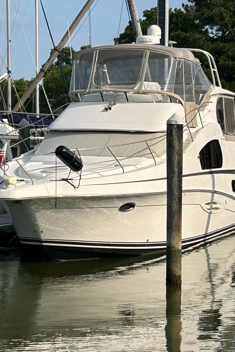 Slide: The Image of 2004 Silverton 39 Motor Yacht docked in a marina. - 2