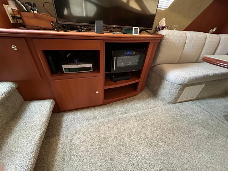 Slide: The Image of 2004 Silverton 39 Motor Yacht interior with entertainment center and seating area. - 21