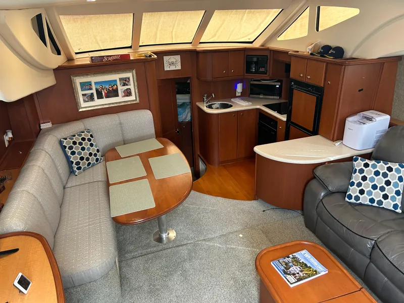 Slide: The Image of Interior of 2004 Silverton 39 Motor Yacht with cozy seating and modern kitchen amenities. - 22