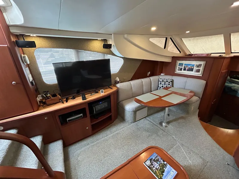 Slide: The Image of Interior of 2004 Silverton 39 Motor Yacht with cozy seating and entertainment area. - 23