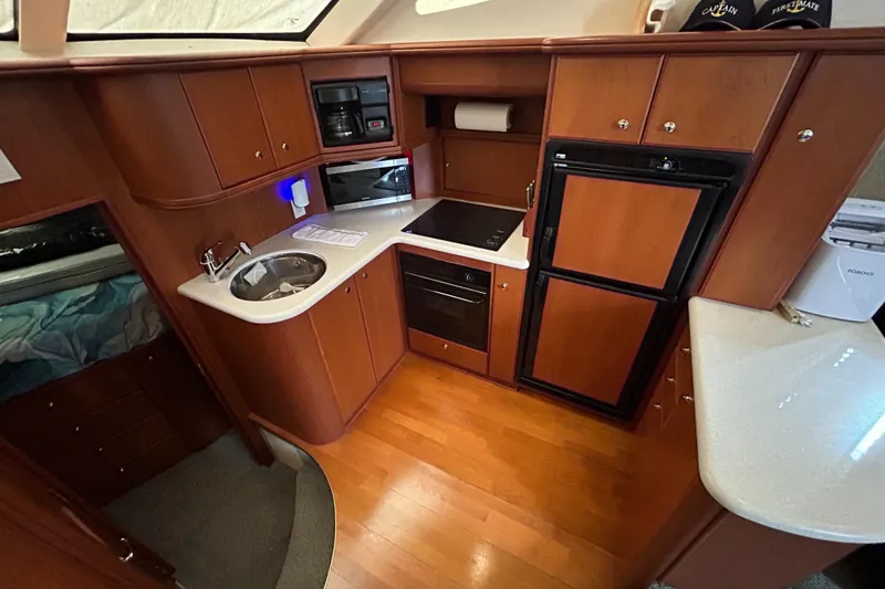 Slide: The Image of 2004 Silverton 39 Motor Yacht kitchen with wood cabinetry and modern appliances. - 24