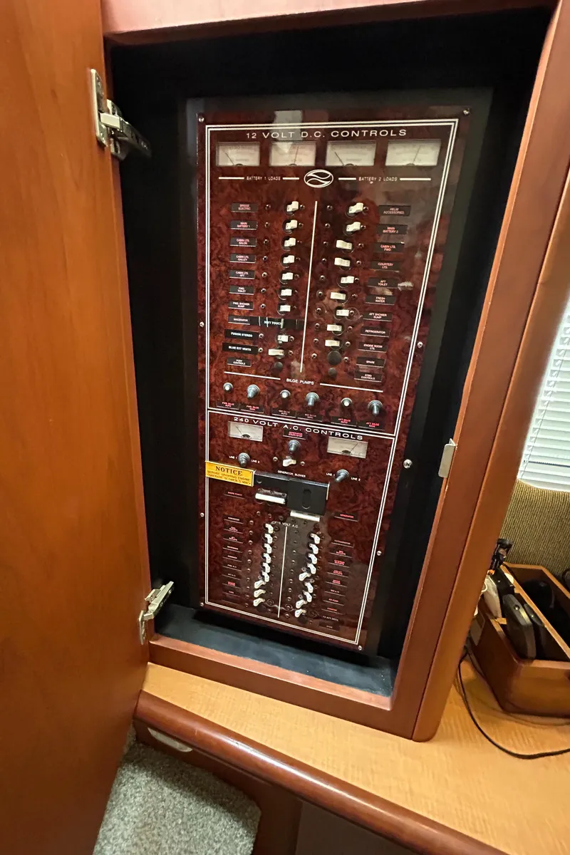 Slide: The Image of Electrical control panel inside 2004 Silverton 39 Motor Yacht, showcasing various switches and controls. - 26