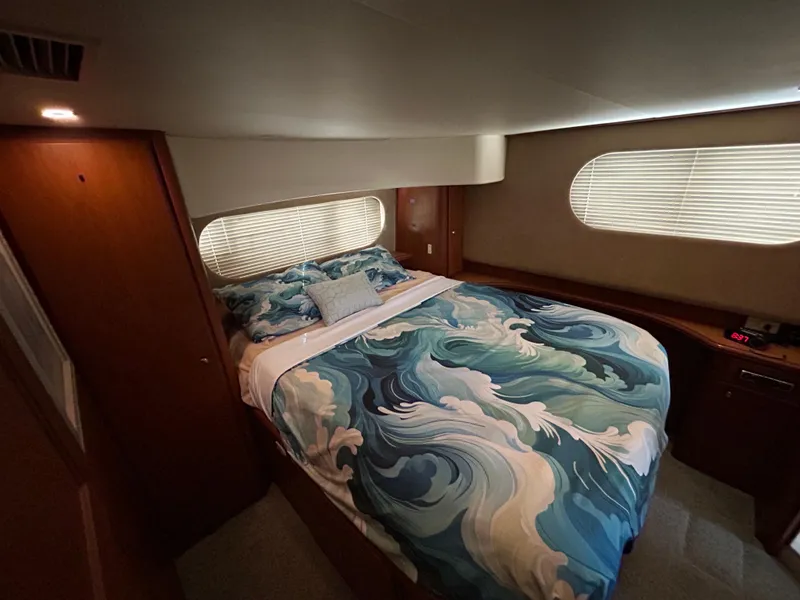 Slide: The Image of Luxurious bedroom in 2004 Silverton 39 Motor Yacht with ocean-themed bedding. - 27