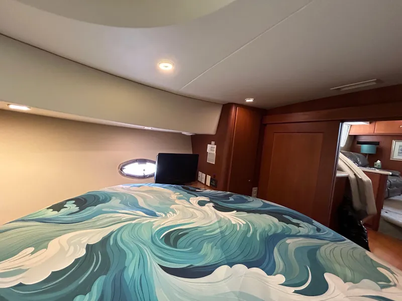 Slide: The Image of Luxurious 2004 Silverton 39 Motor Yacht bedroom with ocean-themed bedding. - 30