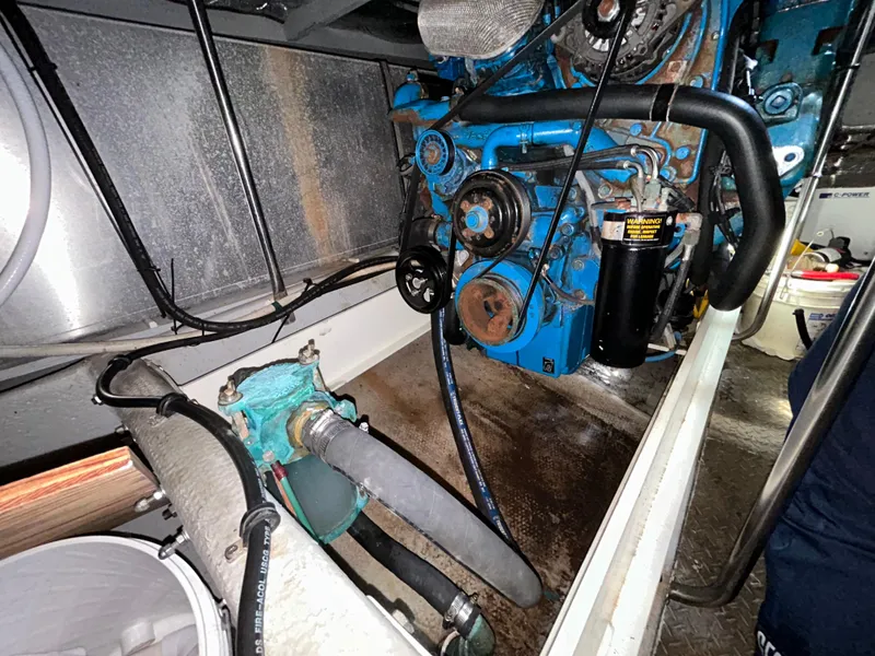 Slide: The Image of Engine room of 2004 Silverton 39 Motor Yacht, showcasing mechanical components and hoses. - 38